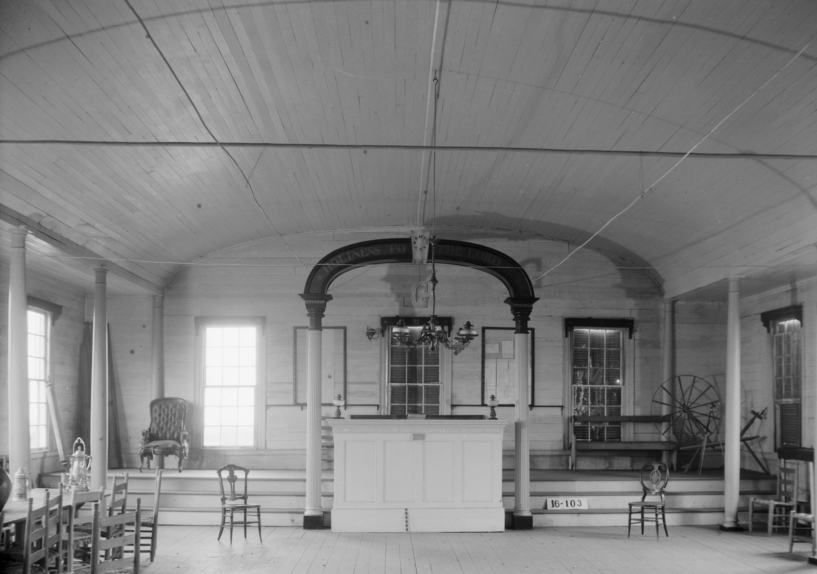 The second-floor lodge room of the Claiborne Masonic hall, a barrel-vaulted room with columns and an arch over the Master's station bearing the letter G, photographed in black and white in 1934.