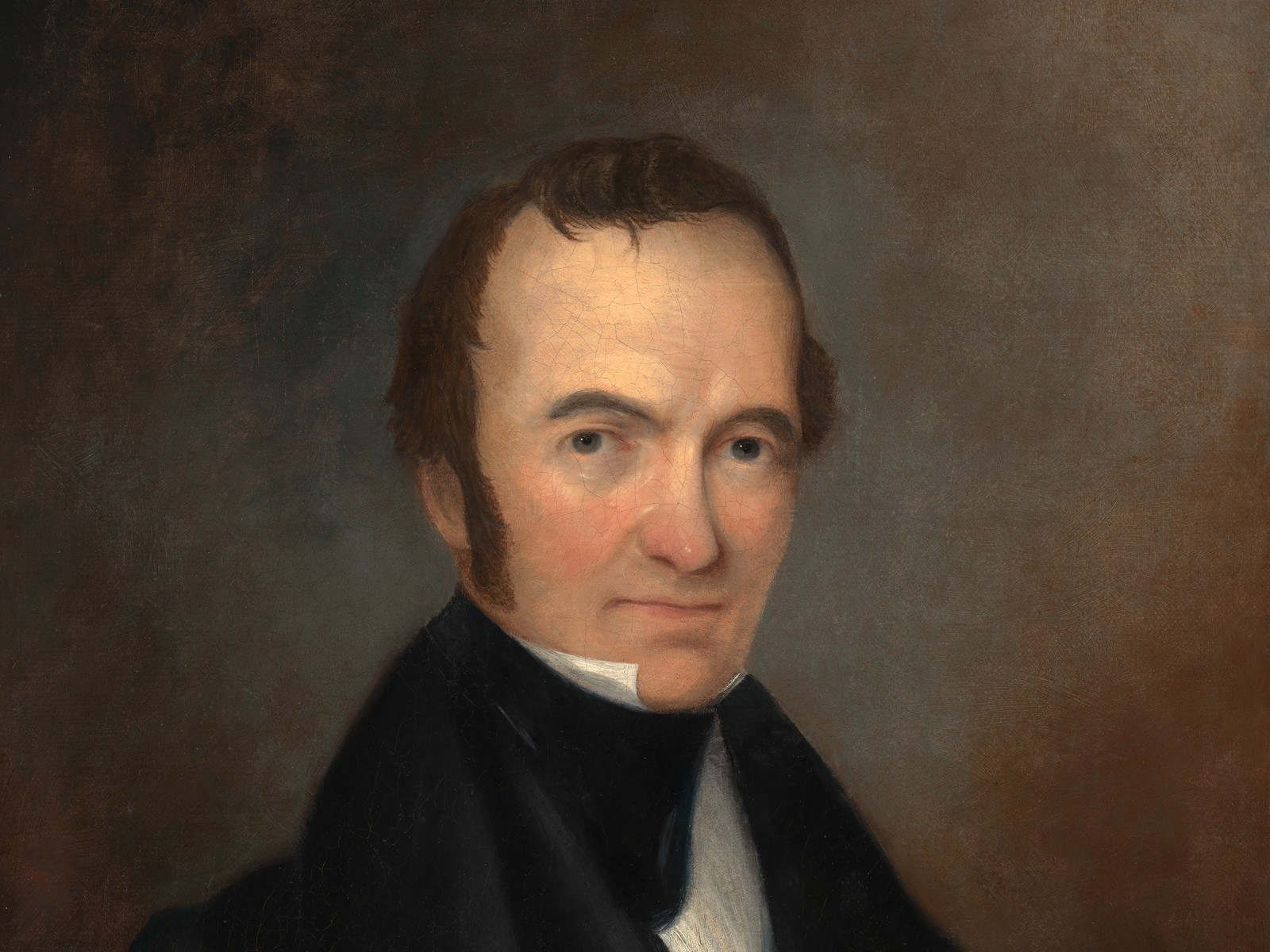 Posthumous oil portrait of Stephen F. Austin, painted about 1840: a slight, balding man in his forties with dark side-whiskers, wearing a black coat and stock over a white shirt, turned three-quarters toward the viewer against a plain brown ground, his expression tired and level.