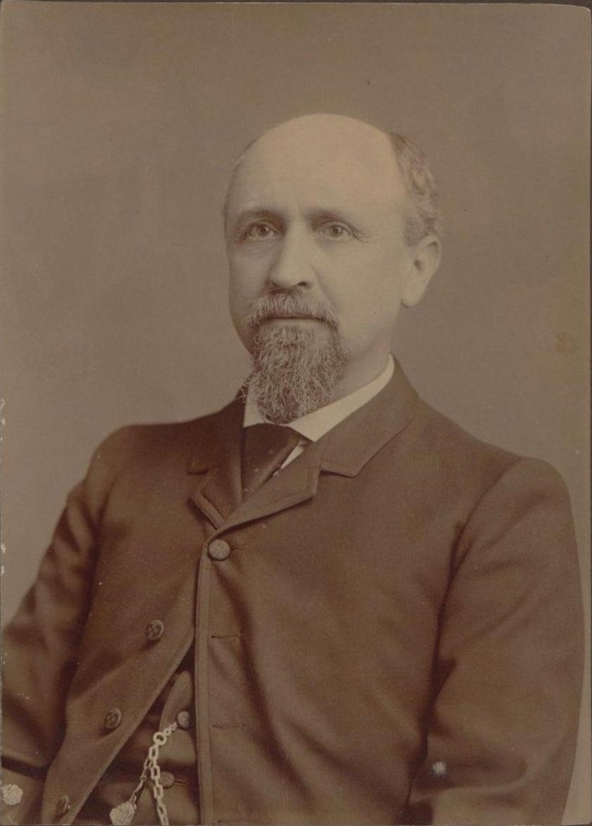 Sepia cabinet-card photograph of Lawrence Sullivan Ross in later life: a balding man with a gray goatee and a level, tired gaze, seated at a slight angle in a dark buttoned sack coat and high collar, a watch chain showing at his vest.